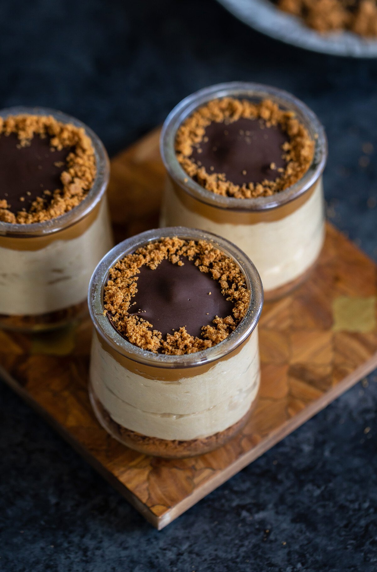 3 biscoff pudding jars arranged on a board 